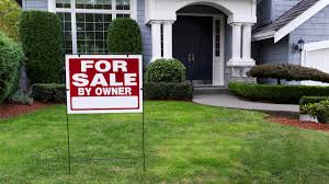 Large home with for sale by owner sign